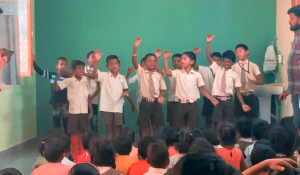 Students performing a song at Grace School. Influence International